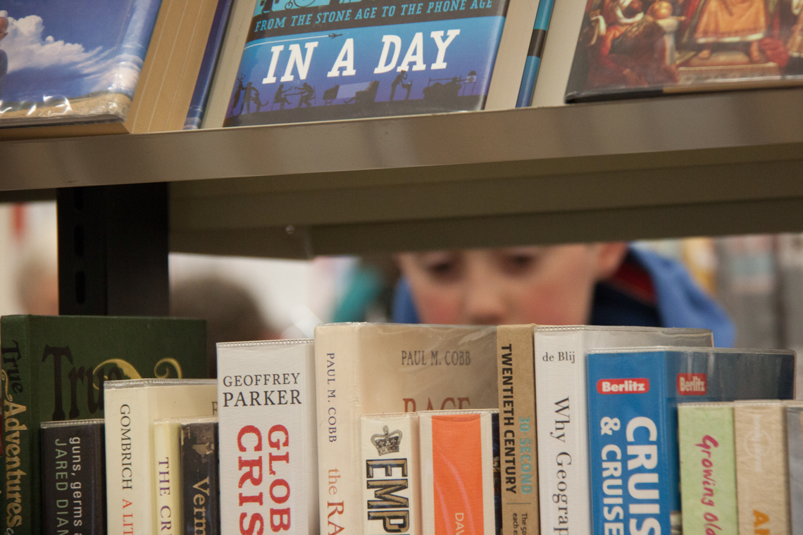 Boy looking through shelves