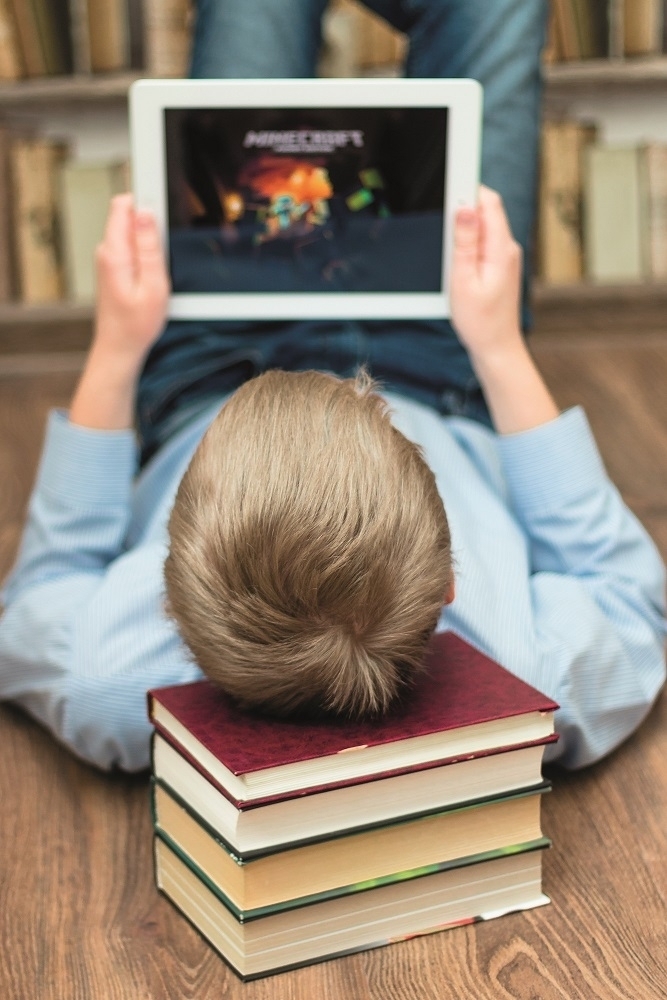 Boy on tablet with Minecraft