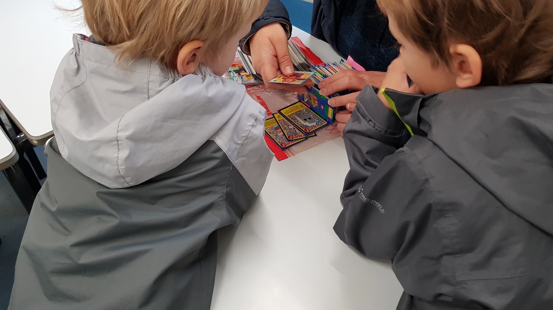 Children looking at LEGO cards